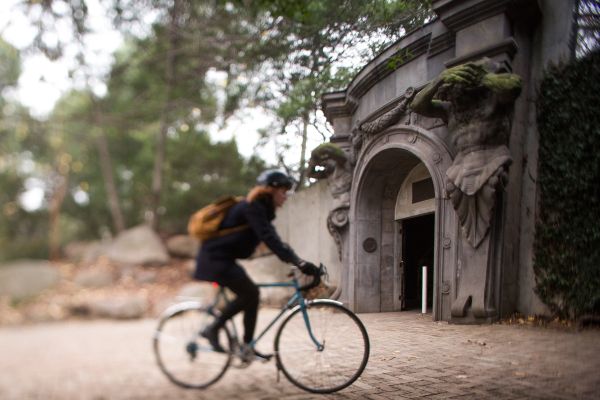 Woman cycling past south lawn carpark entrance