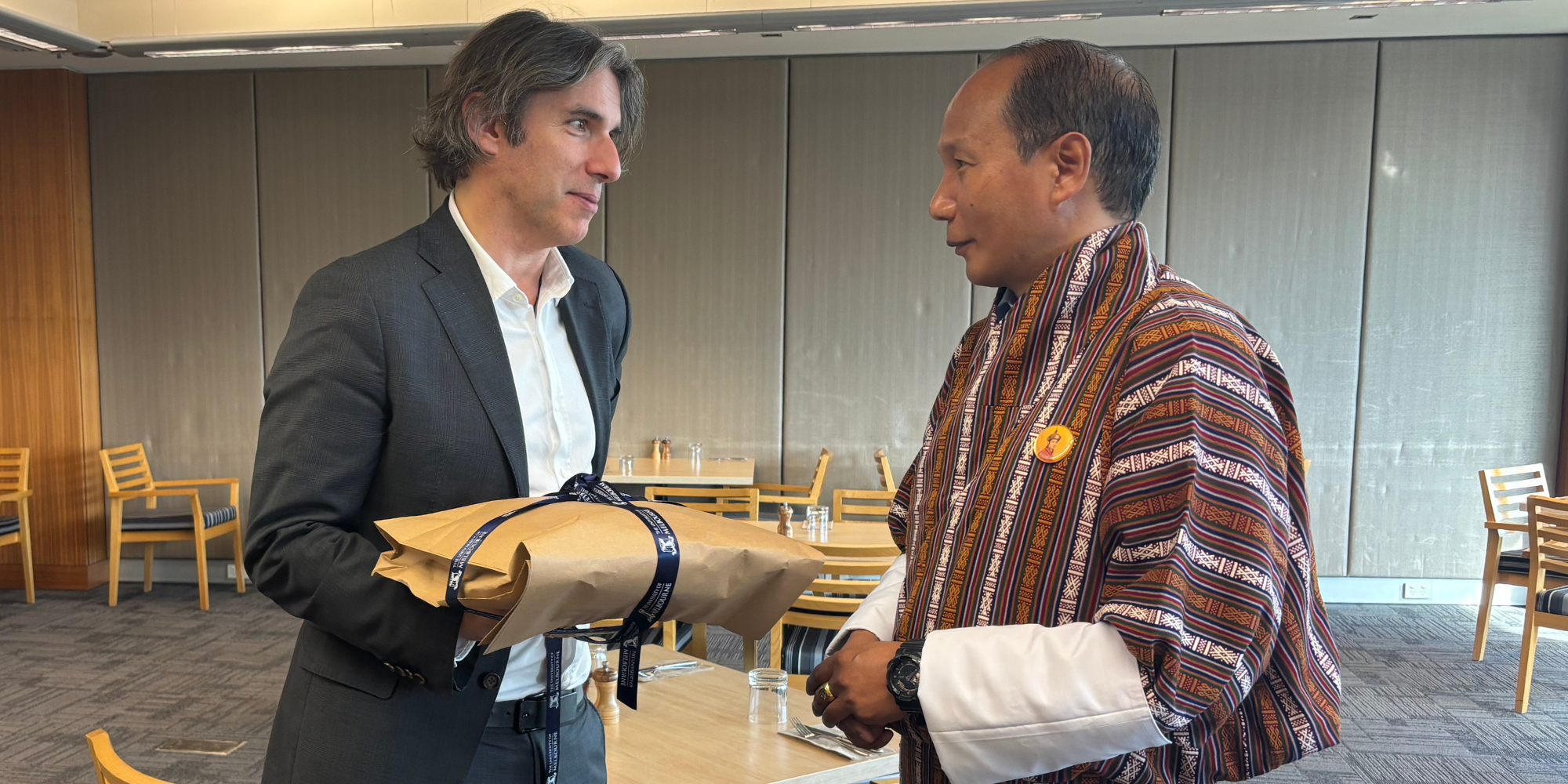 Professor Marek Tesar presents gift to Royal University of Bhutan VC Chewang Rinzin