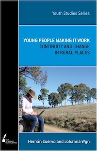 Book cover: Young people making it work. Image: Woman sitting beside country road on laptop