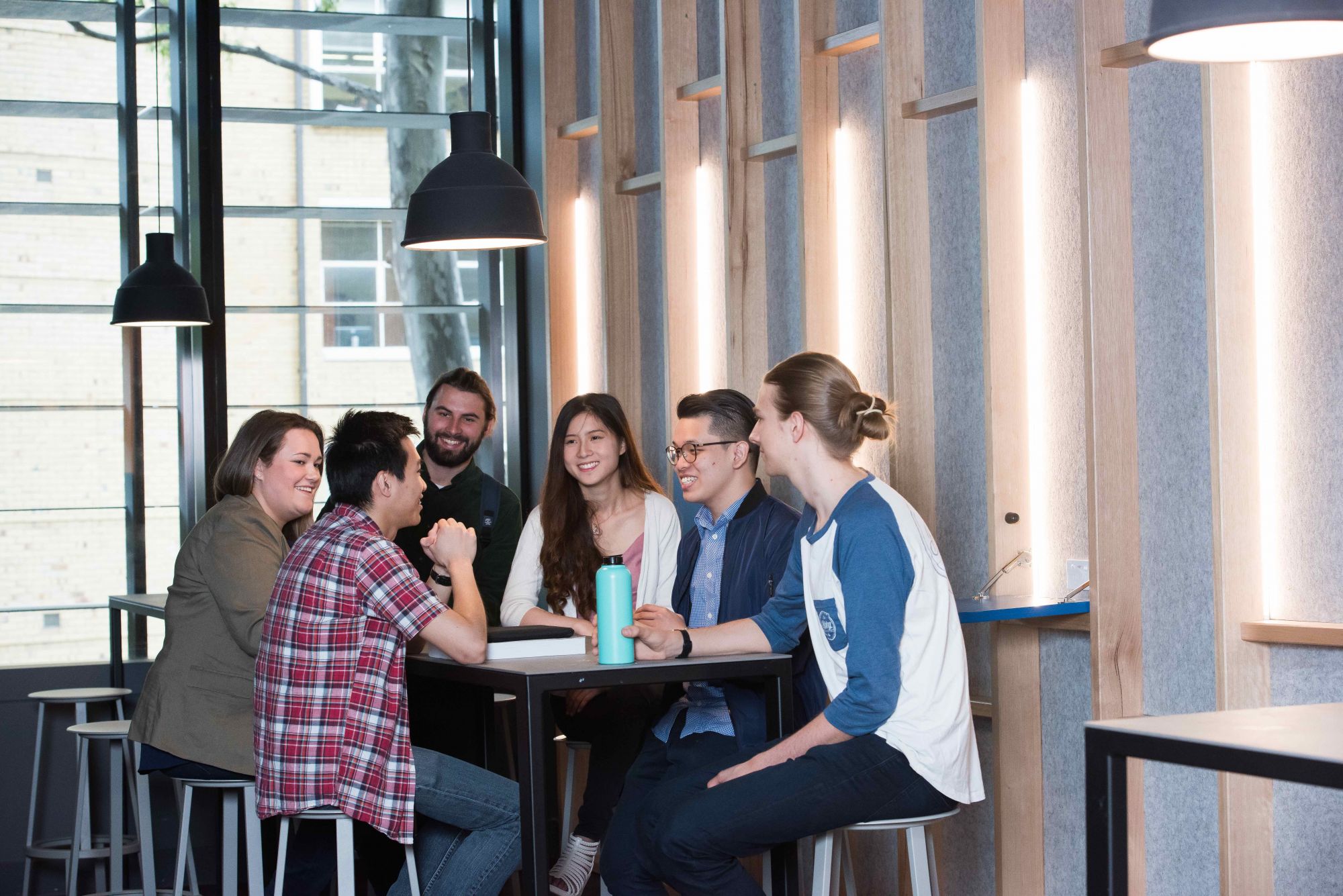 Students sitting around table talking