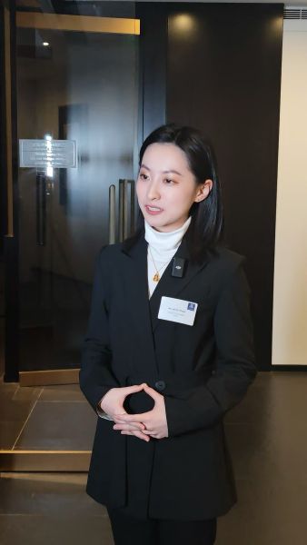 Jenny speaks into a lapel mic